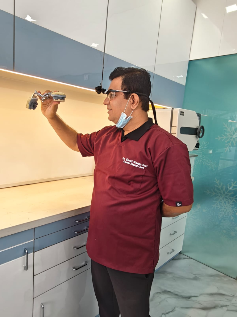 Dr. Quazi Wasim Bari inspecting a dental reconstruction model